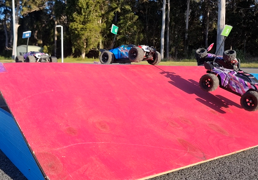 Setup scene: crew assembling the portable arena at a school hall